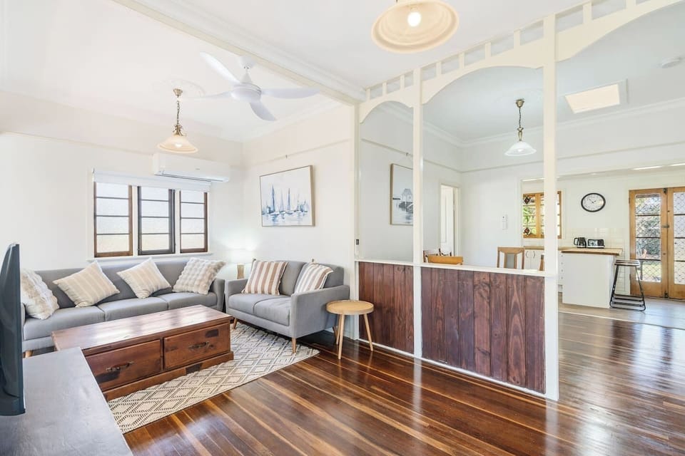 The open-plan design keeps everyone connected, flowing easily from the living area to the dining table and kitchen beyond.