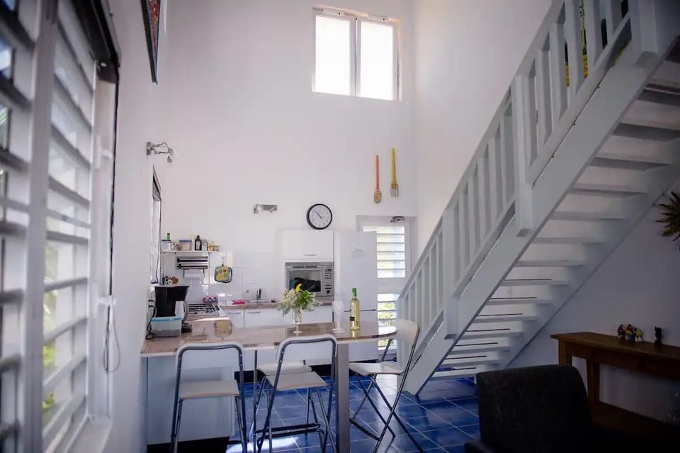 Kitchen with seating.  Stairs to upstairs rooms and balcony.