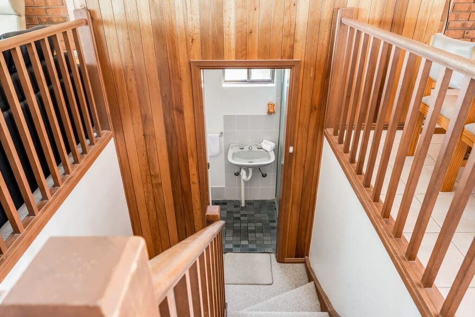 Head downstairs to find the bathroom.