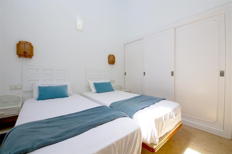 Another picture of the twin bedroom with built-in wardrobes and air-conditioning