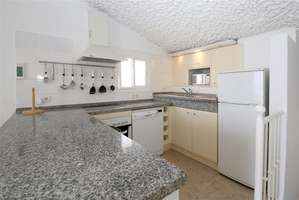 Open kitchen is fully equipped with all the appliances