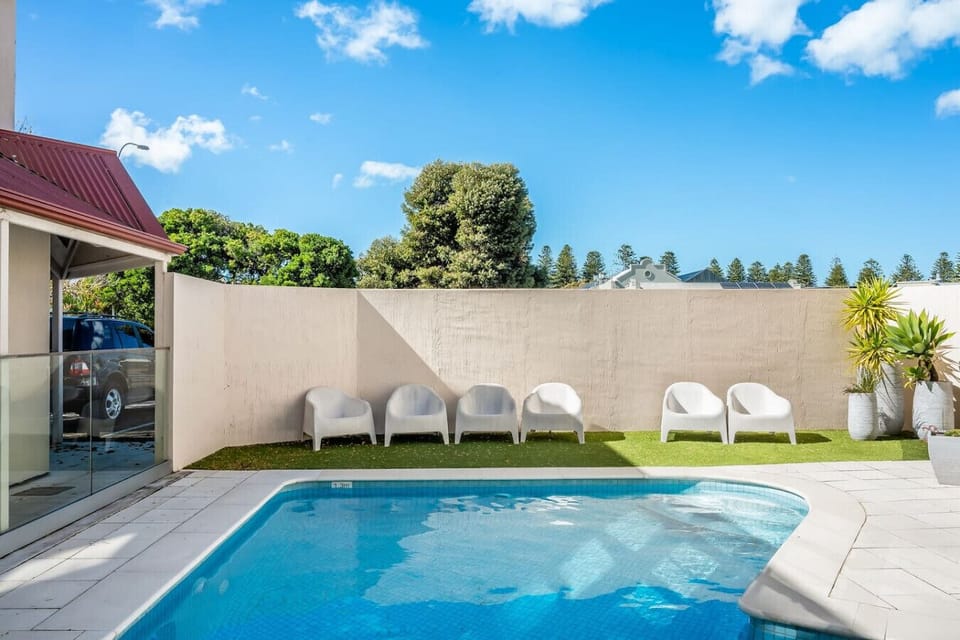Cool off with a refreshing swim in the building`s shared pool after a day at the beach.