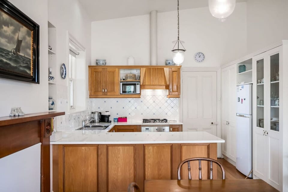 The kitchen boasts a classic design with ample bench space and thoughtful touches throughout.