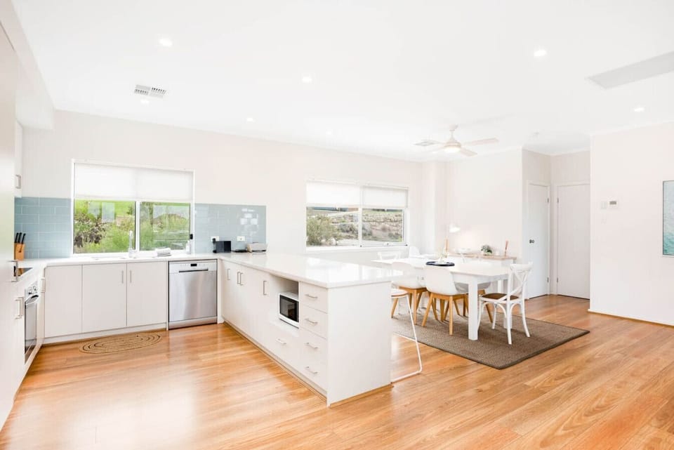 Cook with ease in the bright, modern kitchen, then gather at the dining table to share relaxed meals overlooking the dunes.