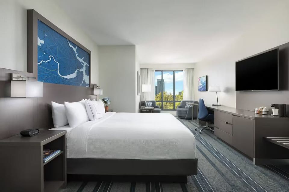 Unwind in a crisp king bed with sunny city views.
