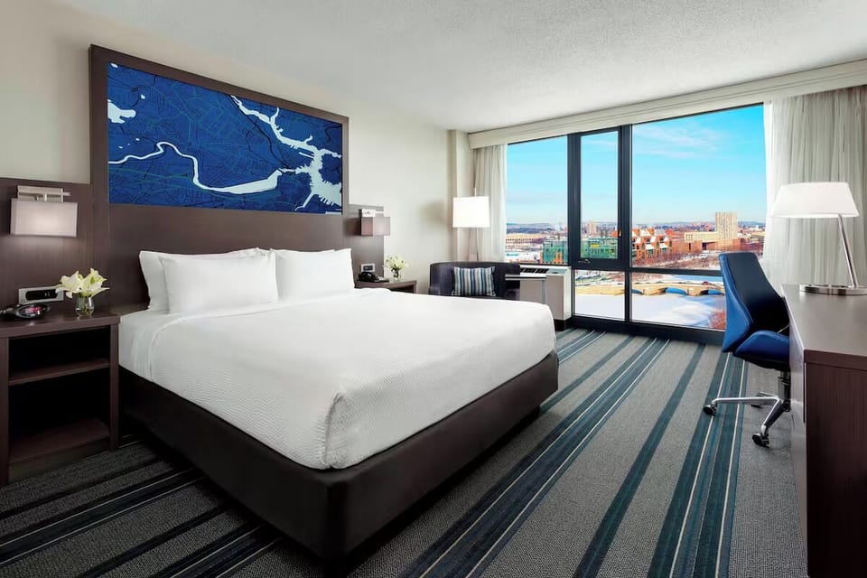 Wake up to sweeping skyline views from your king bed.