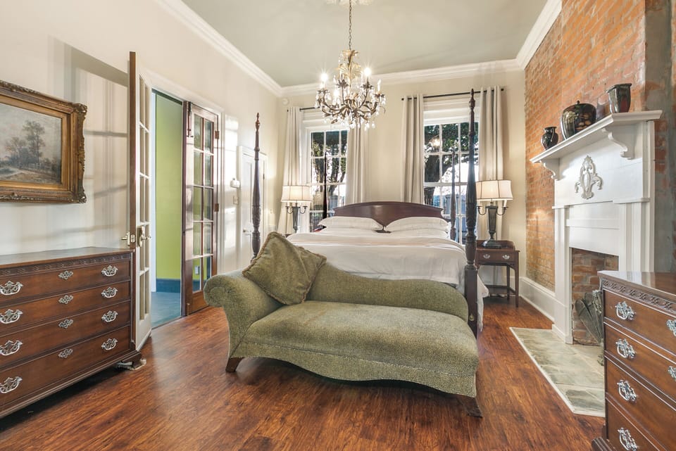 Armstrong's elegant king bedroom with soaring ceilings and inviting decor