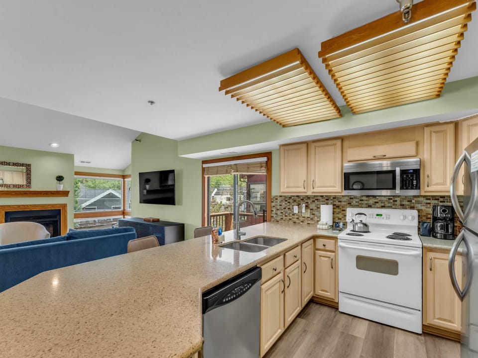Kitchen: Main floor, drip coffee maker, toaster, cooking utensils, tableware

