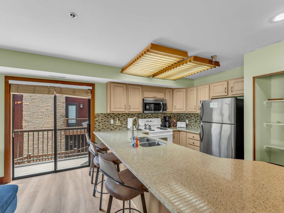 Kitchen: Main floor, drip coffee maker, toaster, cooking utensils, tableware

