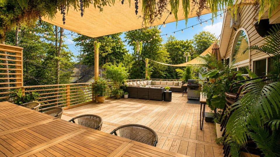 Spacious rooftop terrace with multiple seating areas and lush greenery.
