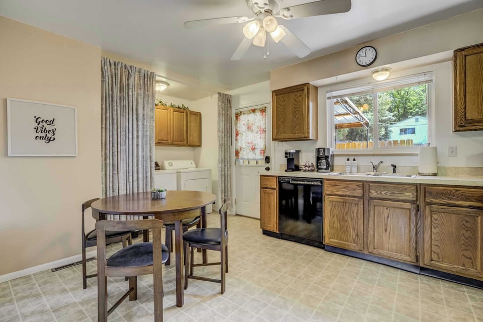 Bright and functional kitchen with full-size appliances, a coffee station, and a cozy dining nook just steps from the laundry area.

