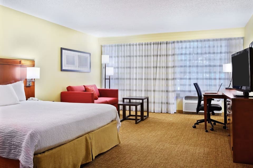Unwind in a bright king room with work desk.