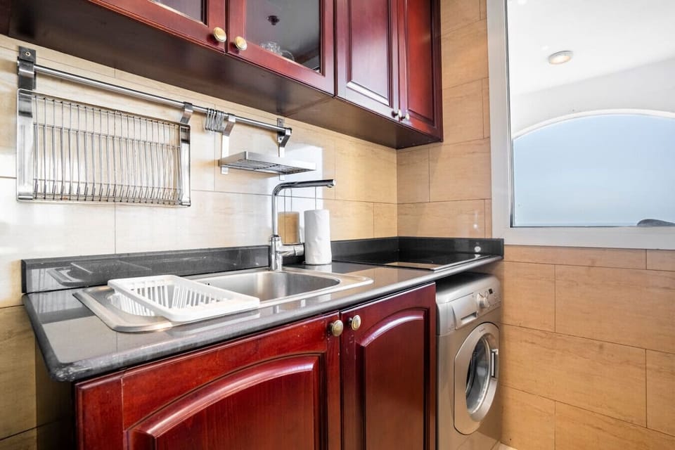 Kitchen: Enjoy a functional space with modern appliances and stylish wood accents!