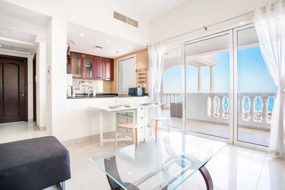 Living Room: Bright and airy space with stunning sea views, modern decor, and inviting dining area!