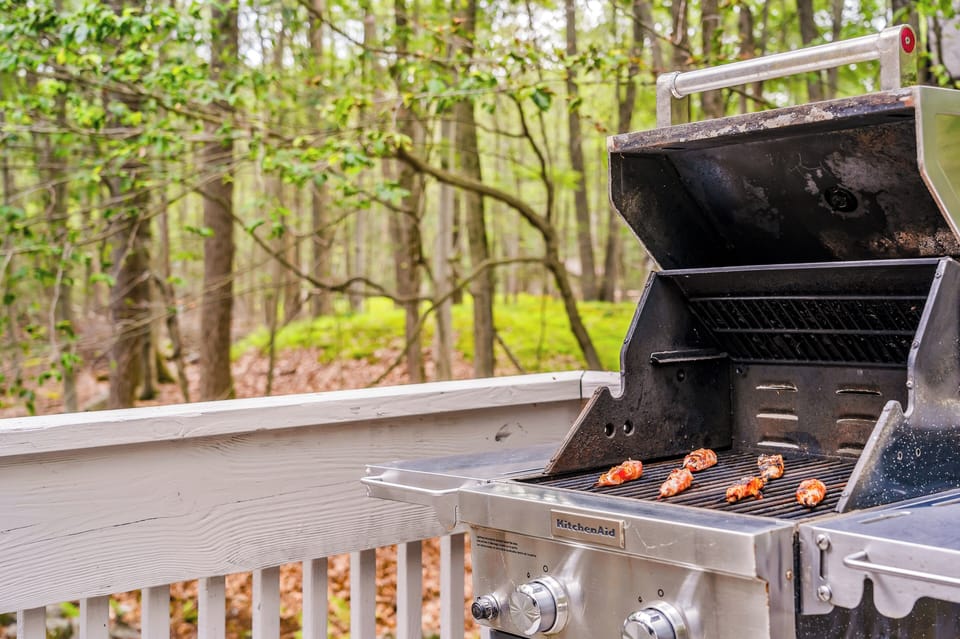 Grill up your favorites on the outdoor propane BBQ while enjoying serene woodland views.