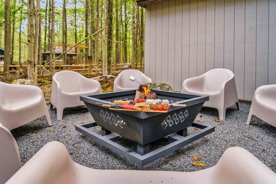 This stylish outdoor fire pit area features modern seating, woodsy surroundings, and the perfect setup for s’mores and late-night conversations under the stars.