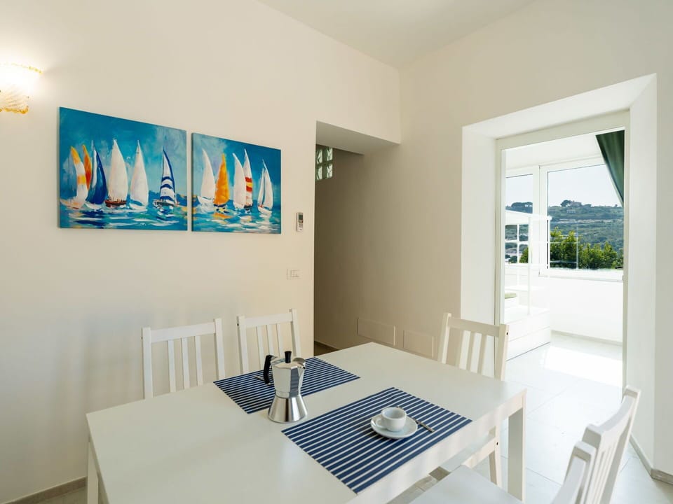 Furniture, Chair, Outdoor Furniture, Table, Outdoor Table, Kitchen & Dining Room Table, Umbrella, Shade, Restaurant, Patio