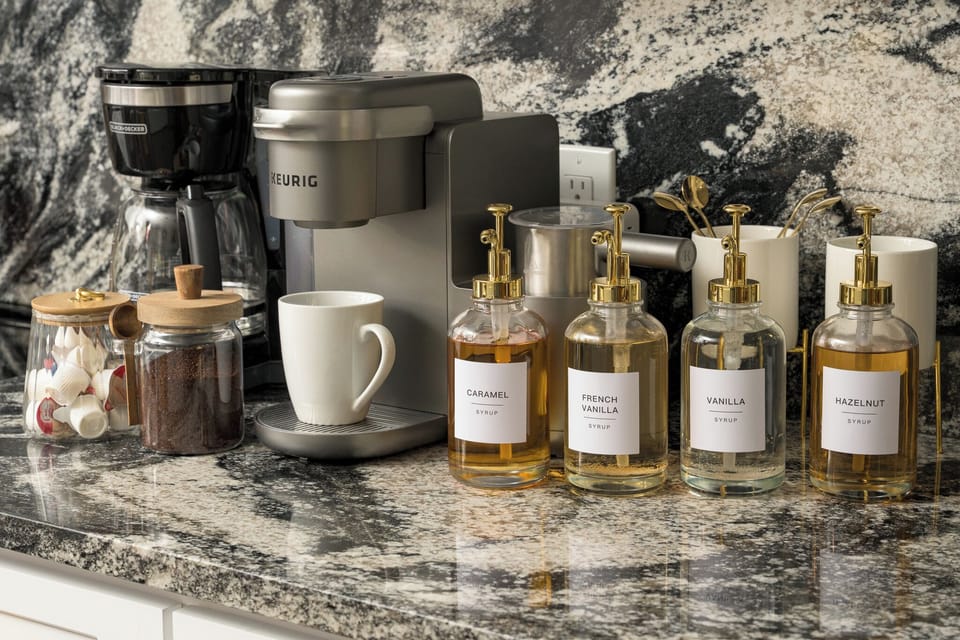 Start your amazing day right with a fully stocked coffee bar featuring Keurig and drip options, plus a variety of syrups and sweeteners.