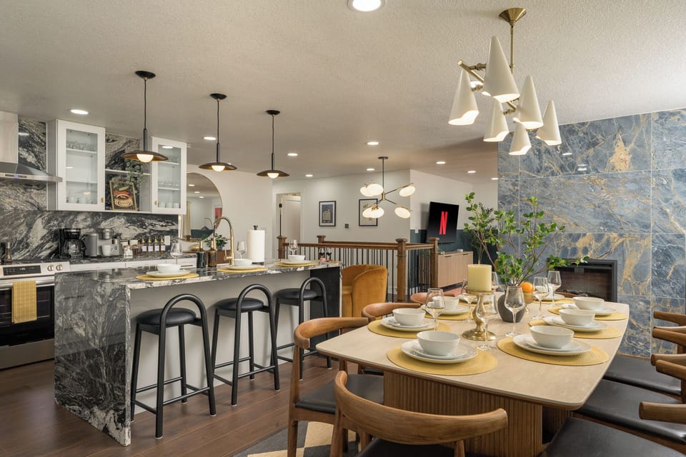 This bright, open-concept kitchen and dining area blends modern design with warm, inviting finishes—perfect for shared meals.