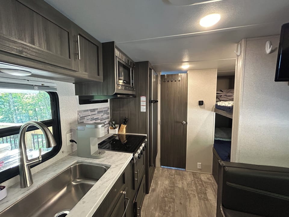 Stove (no oven), sink, microwave and fridge/freezer