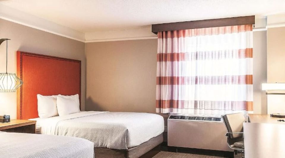 Wake up to soft daylight beside a handy work desk.