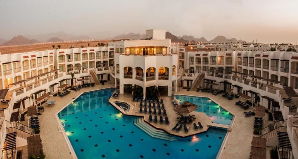 Soak up golden-hour vibes beside the sparkling resort pools.