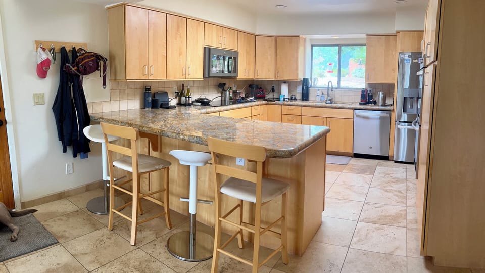 Kitchen and breakfast bar with cooktop and microwave