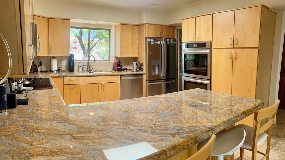 Kitchen with side-by-side refrigerator and double oven