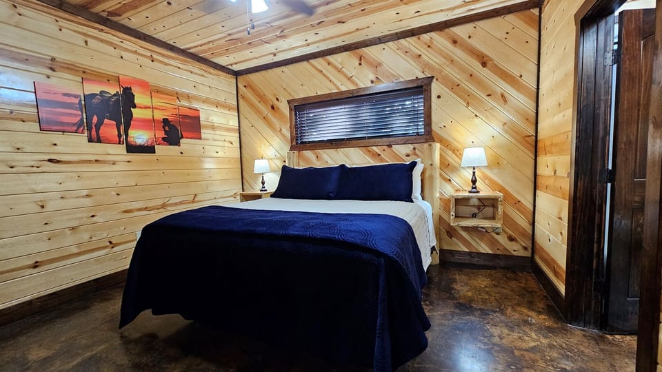 Bedroom Retreat: Rustic charm awaits with wood accents and serene sunset art for ultimate relaxation!