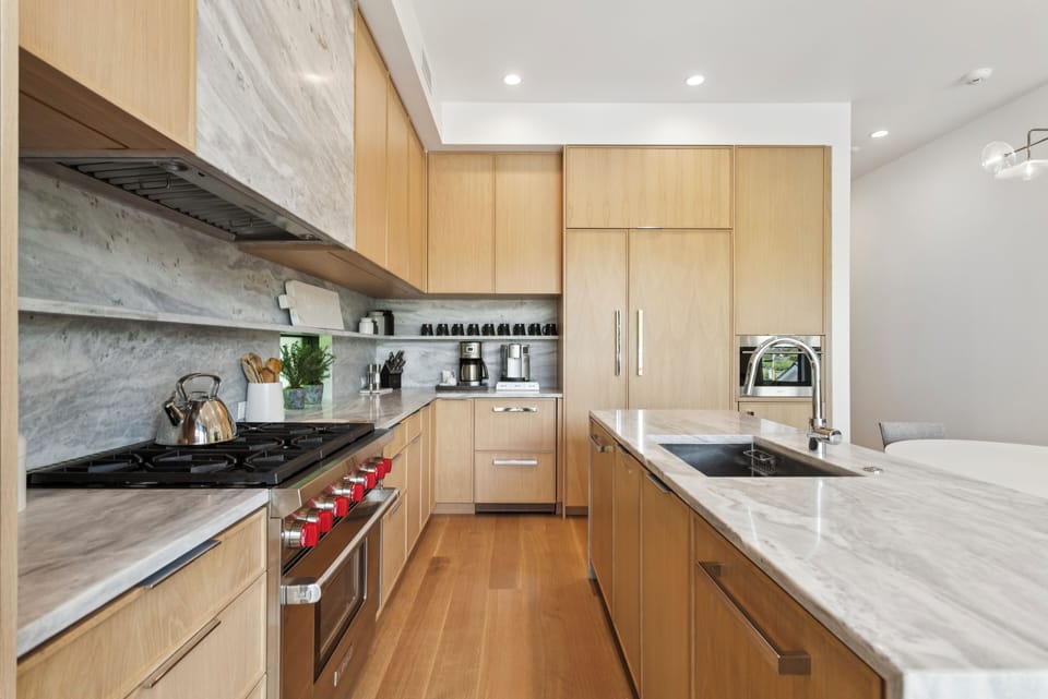 a large gourmet kitchen with professional stove and lots of storage and prep space