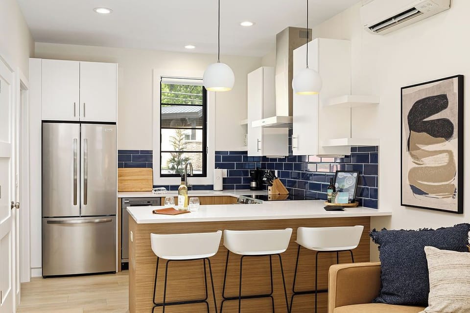 Chic and functional—this kitchen blends modern amenities with warm wooden cabinetry and stylish accents.