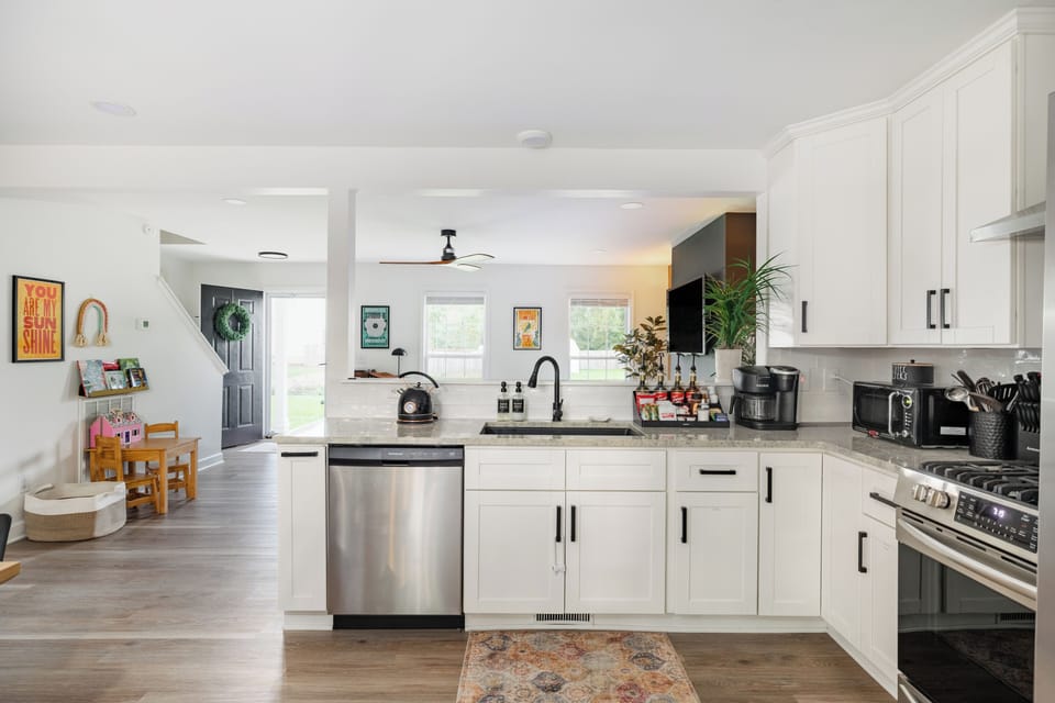 The kitchen is fully stocked with updated appliances and cookware.