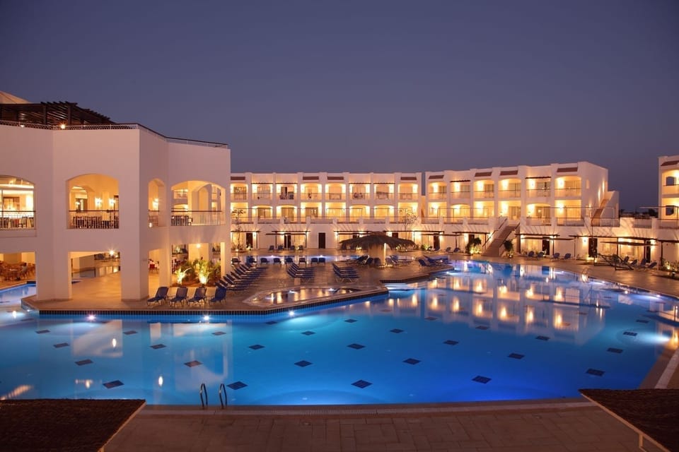 Unwind poolside at sunset with loungers and calming reflections.