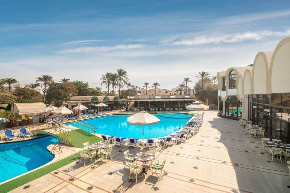 Dive into sunlit bliss with loungers and resort-style pool views