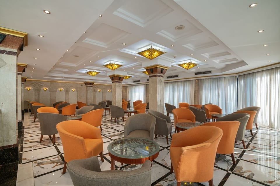 Relax in the elegant lounge with soft chairs and warm lighting
