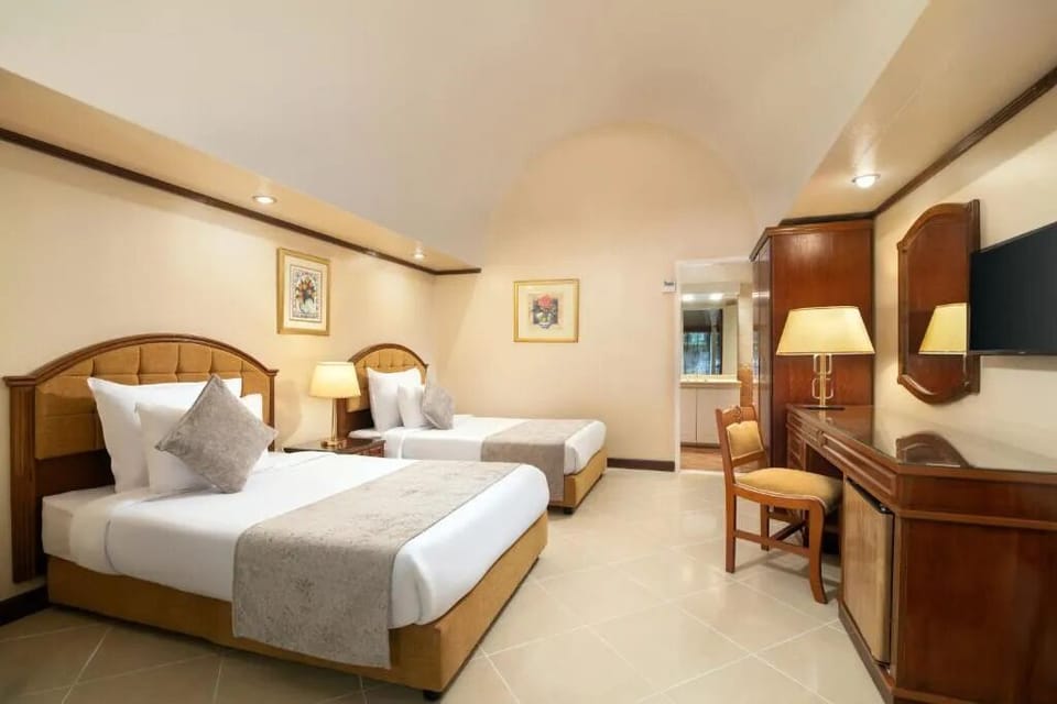 Share the space comfortably with two inviting beds and warm lighting.