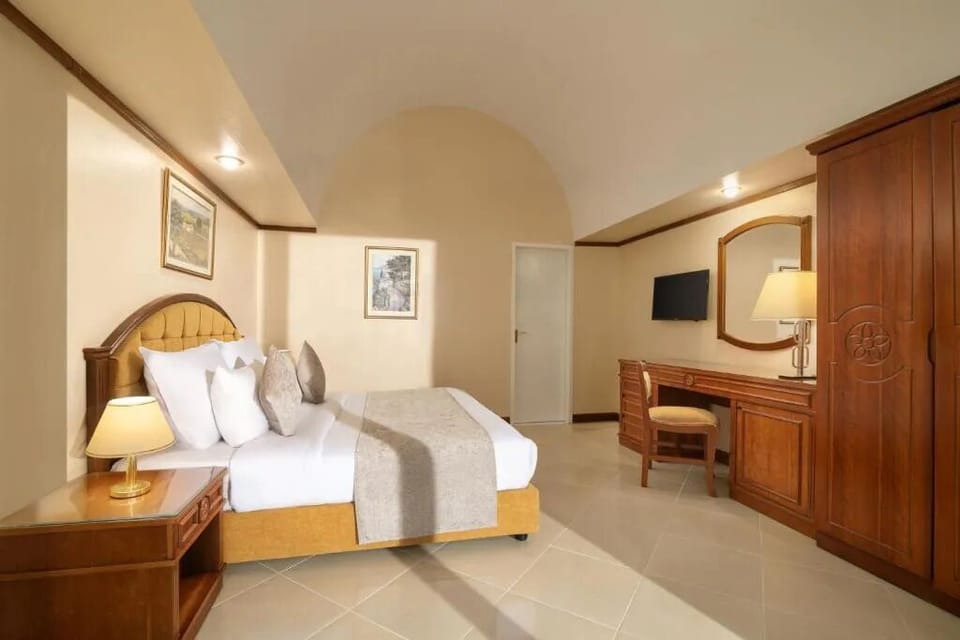 Recharge in a calm bedroom with warm, hotel-style comfort.