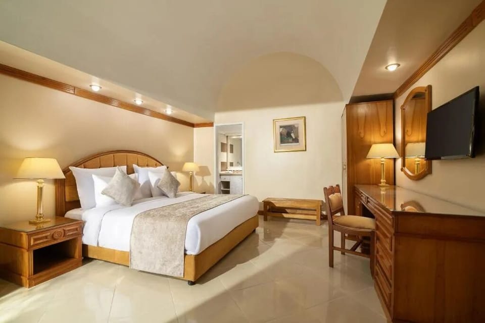 Unwind in a spacious room with cozy lighting and workspace.
