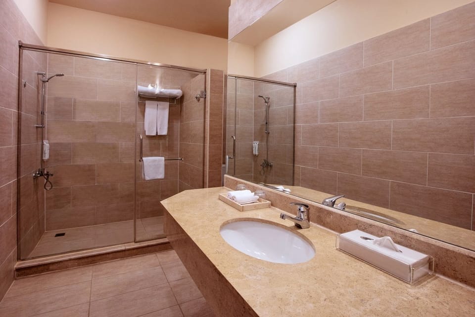 Refresh under the glass shower in a bright, spa-like bath.