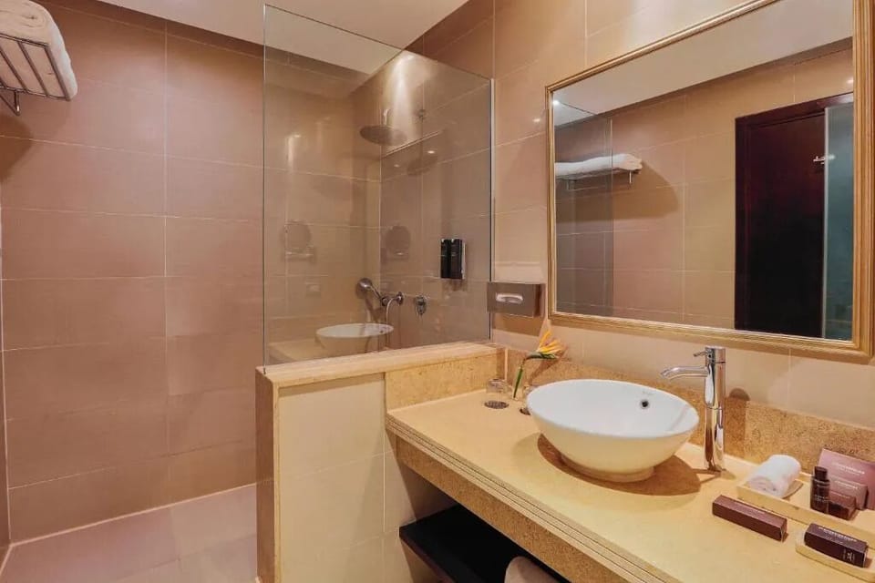 Refresh under a rainfall shower in a spa-like setting.