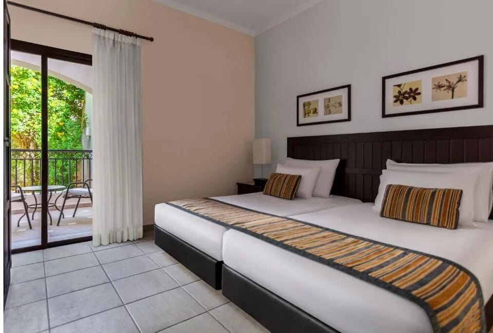 Unwind in crisp twin beds beside your private terrace.