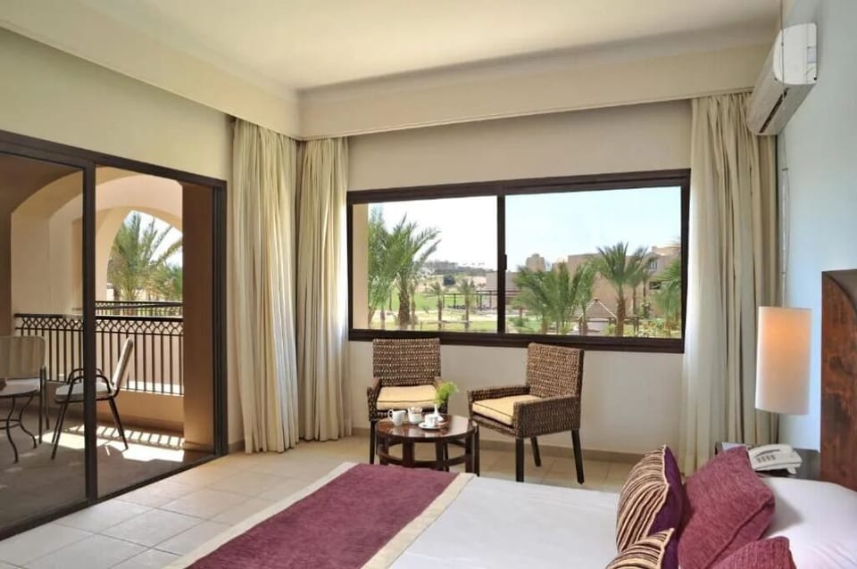 Sip morning coffee beside bright windows and cozy armchairs.