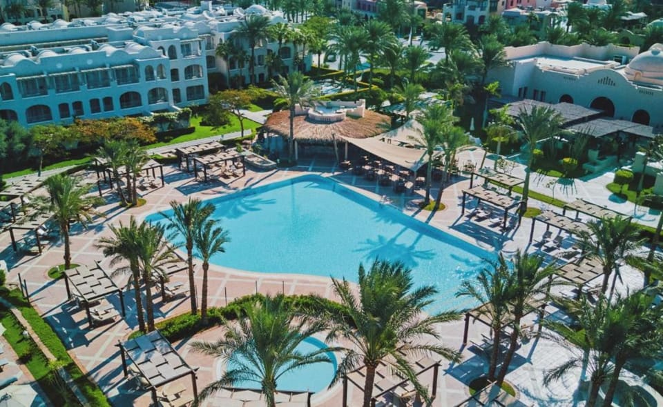 Settle into poolside comfort with views of elegant resort balconies.