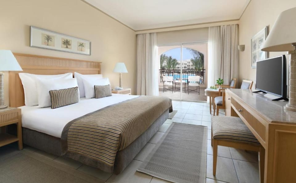 Recharge in a bright king bedroom with balcony vistas.