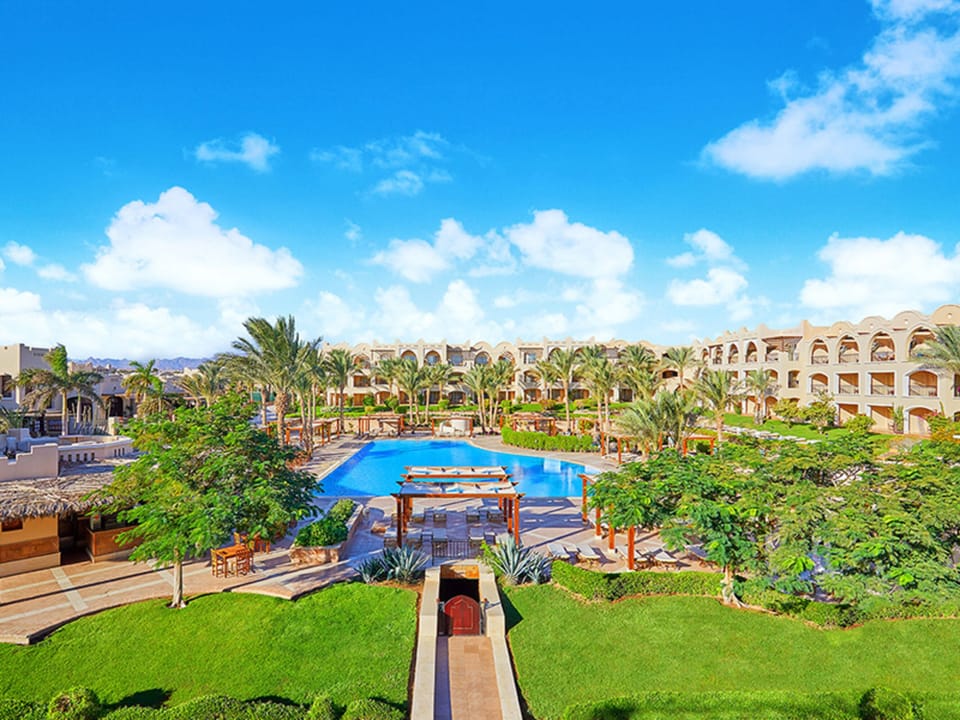 Wander through manicured gardens framing the central lagoon pool.