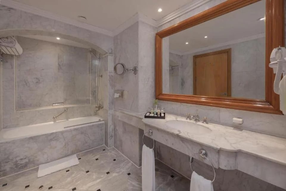 Refresh in a marble bathroom with deep soaking tub.