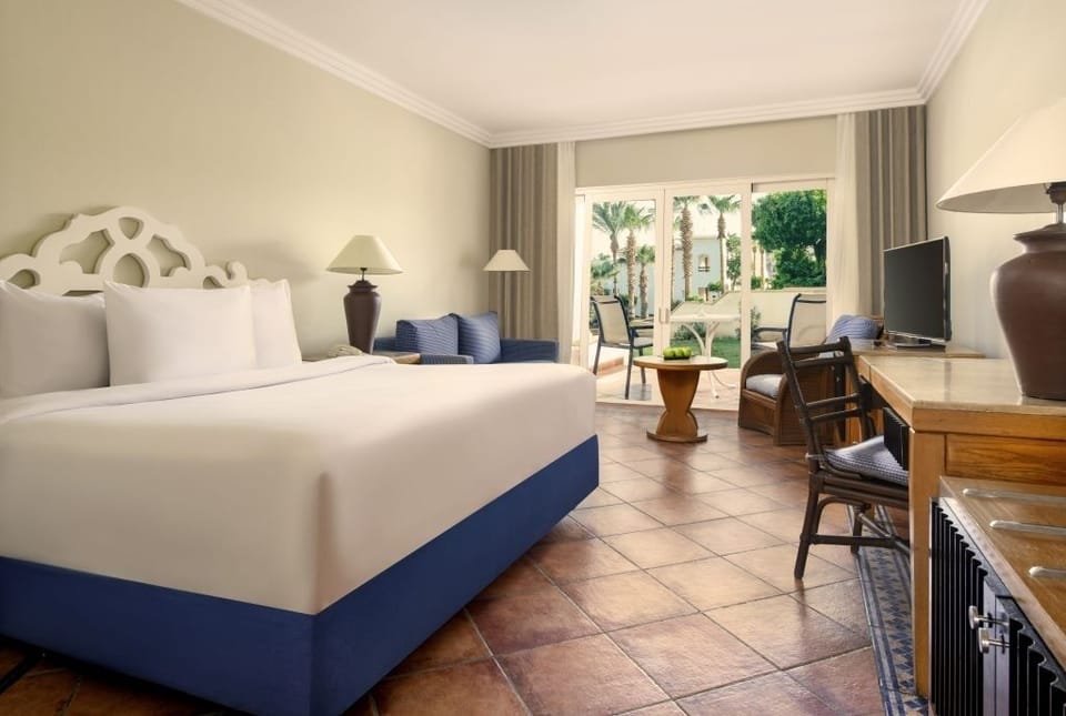 Wake up to garden views from a crisp, airy king bed.