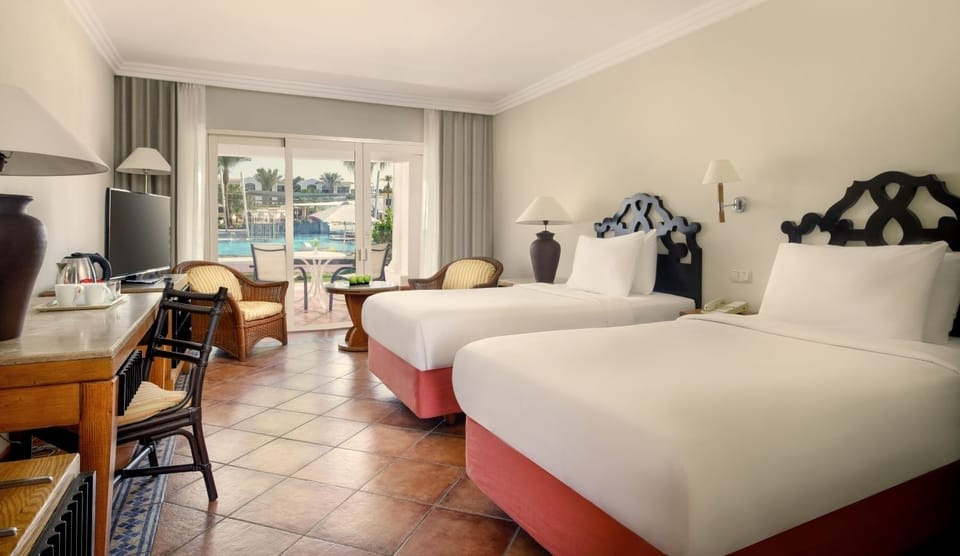 Spread out comfortably with two beds and sunny patio views.