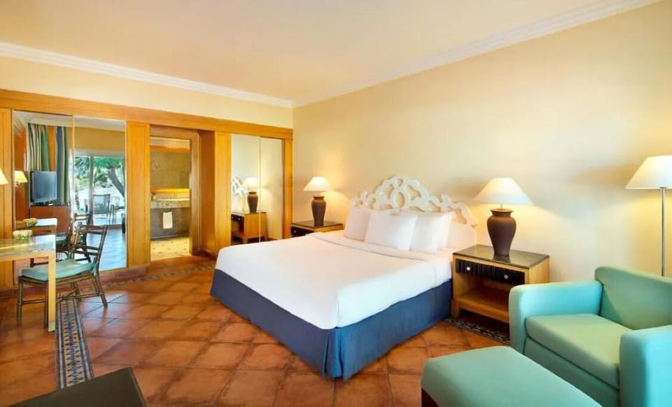 Recharge on crisp linens in a serene, spacious bedroom.