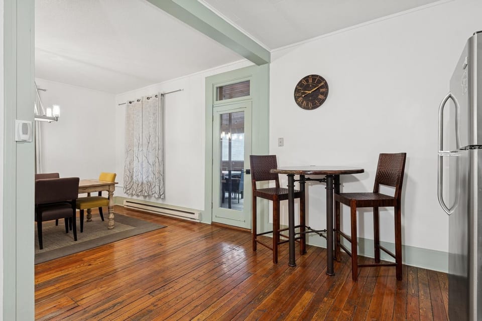 Step into your charming dining space with gleaming hardwood floors and cozy bistro seating perfect for morning coffee or evening meals.